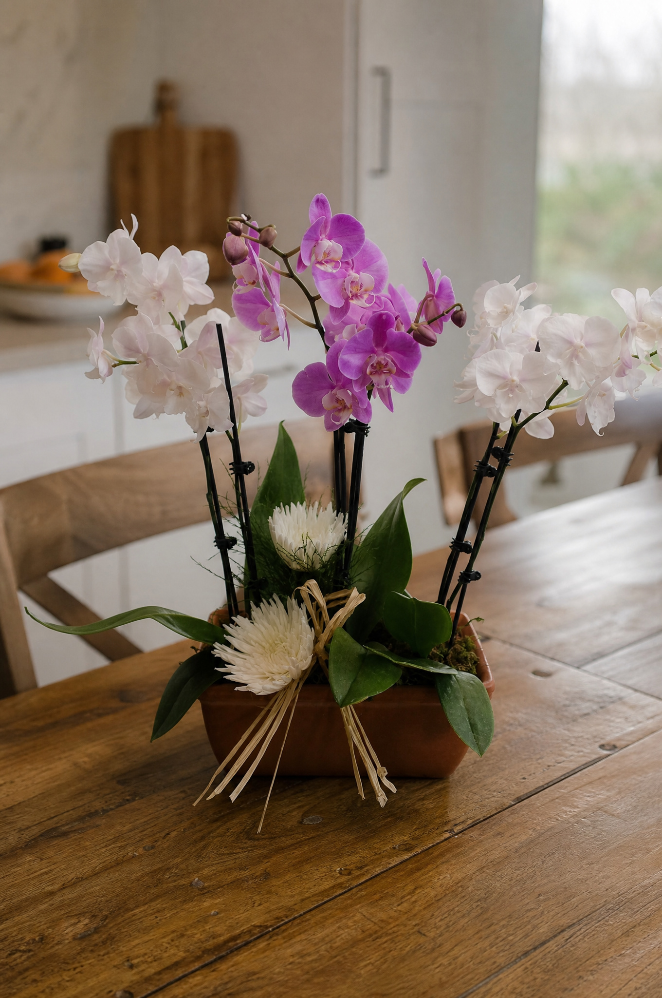Add fresh flowers to complete the centerpiece
