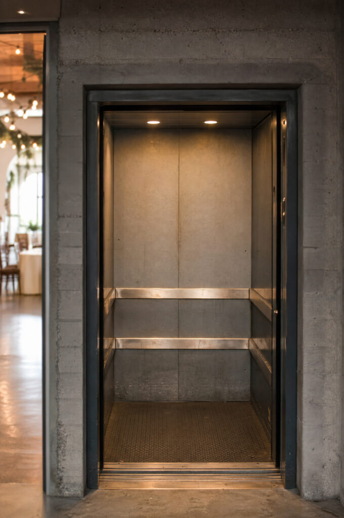 Small service elevator doorway at an event venue being measured