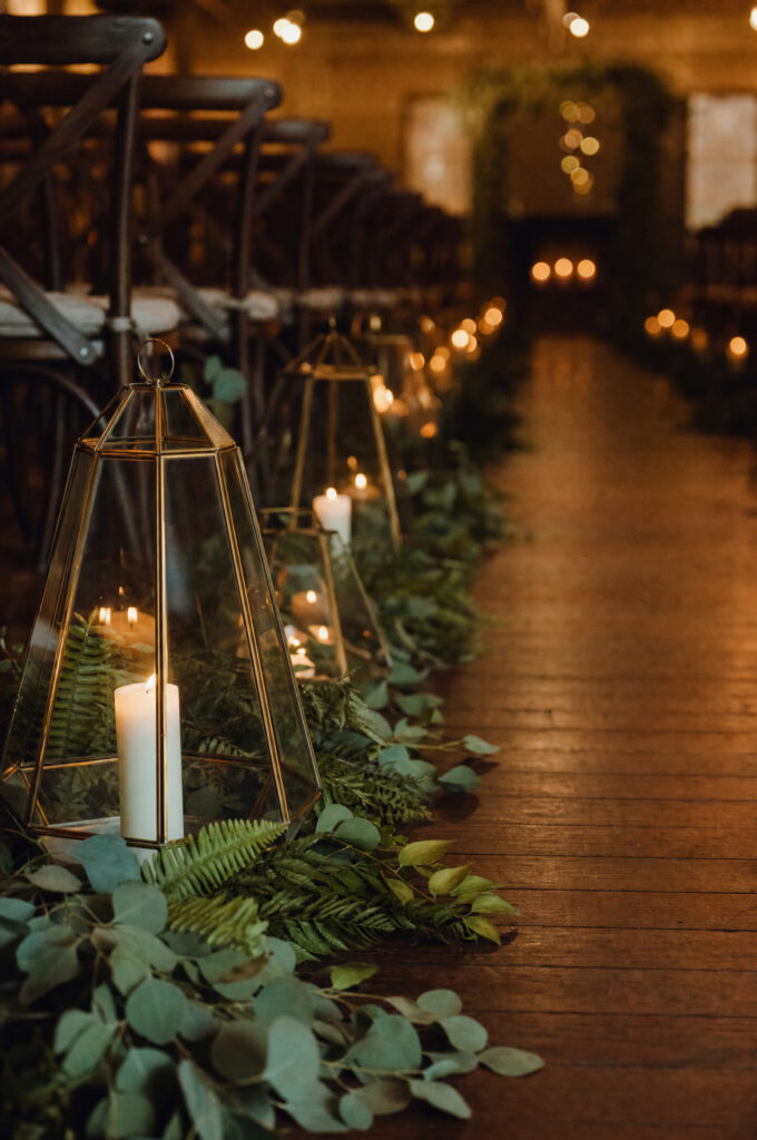 aisle lanterns candles greenery