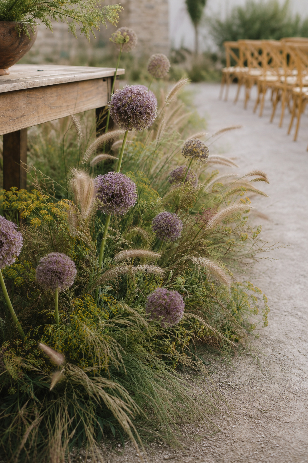Large sculptural floral arrangement at the entrance to a wedding ceremony aisle