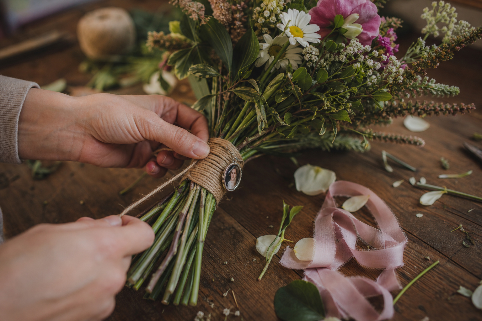Country wedding bouquet stem wrap with twine and a small memorial photo charm