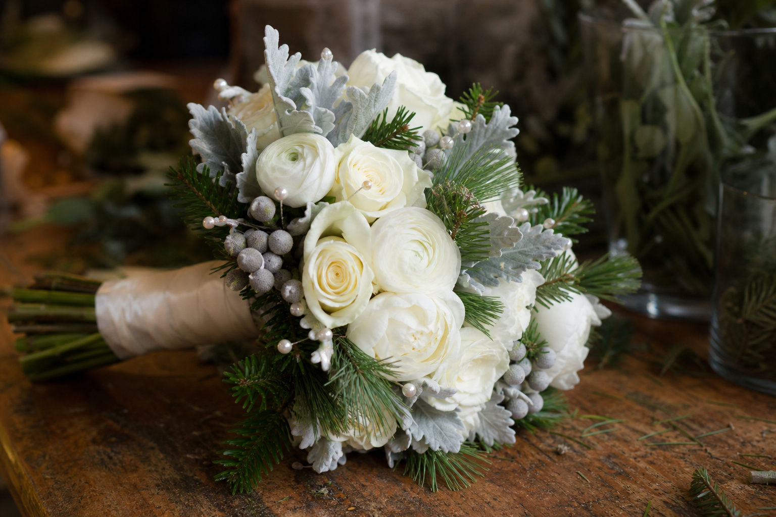 Classic white rose and pine winter wedding bouquet with silver brunia and dusty miller