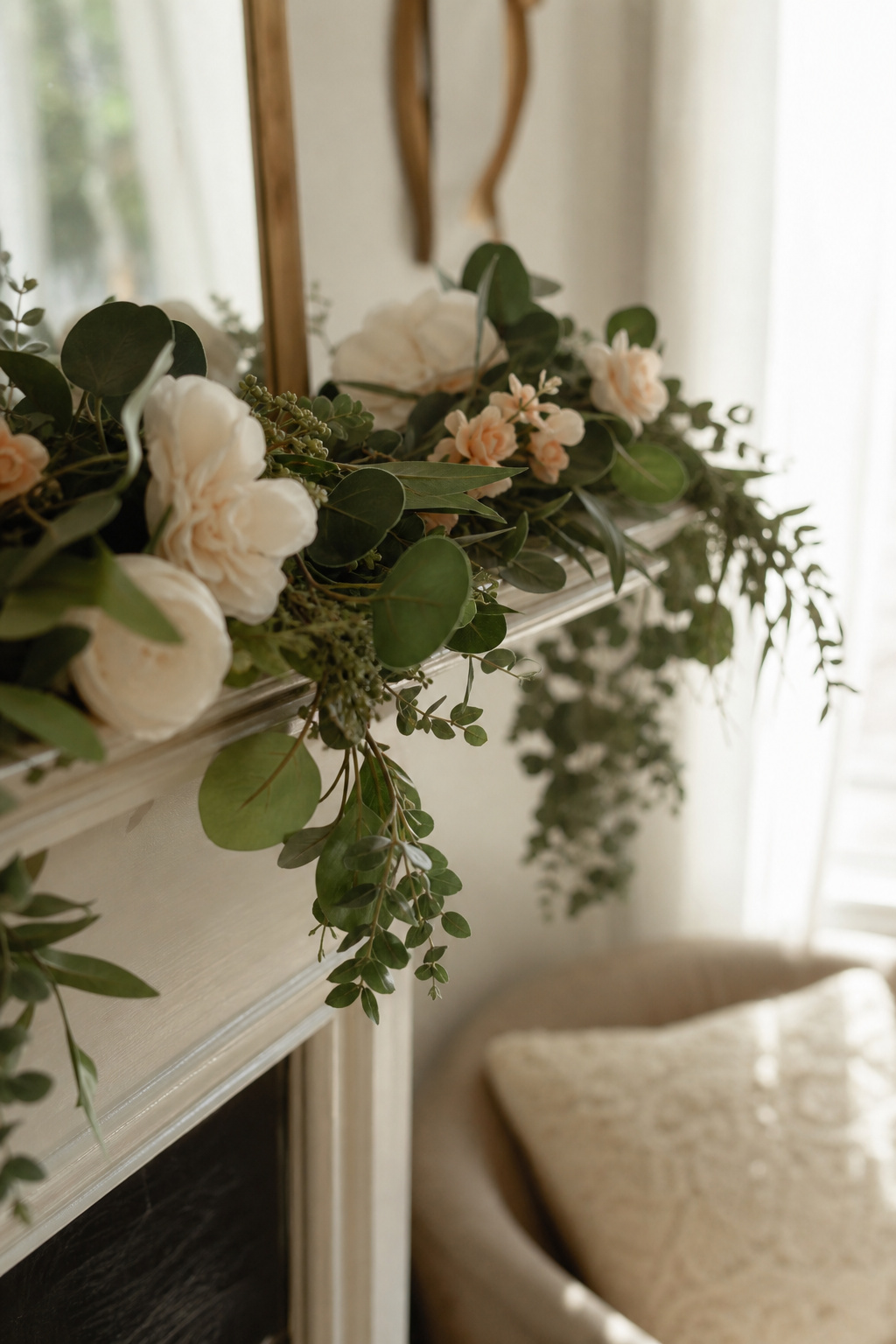 Fresh eucalyptus garland mixed with silk flowers draped along a mantle
