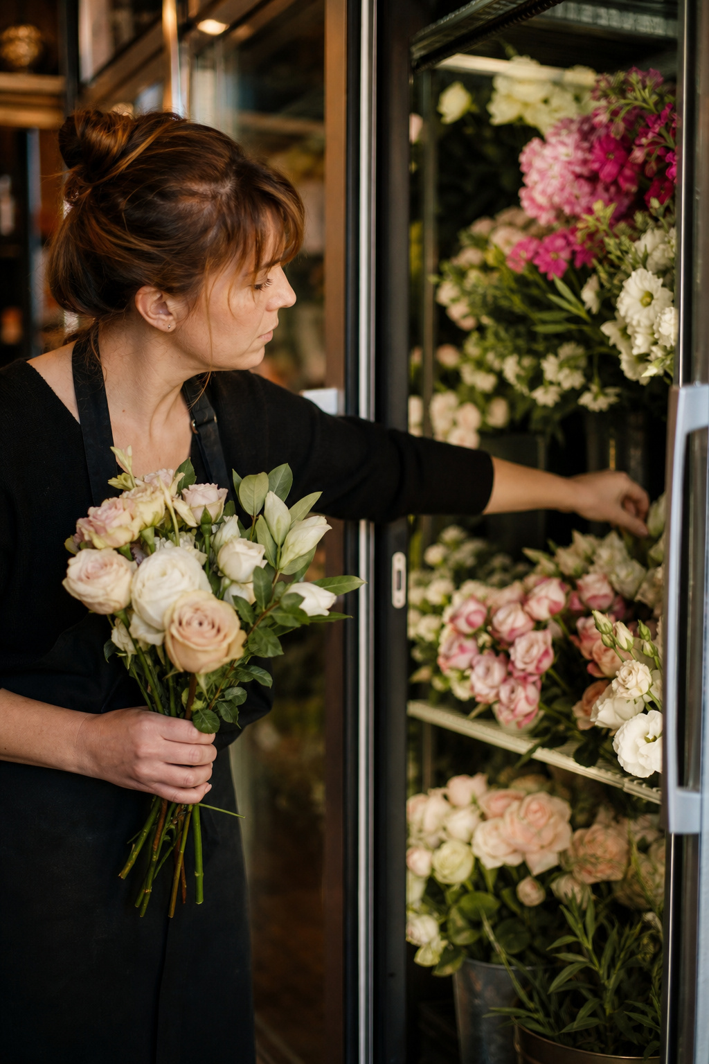 Fresh cut flowers being selected for wedding cake styling in a flower shop cooler