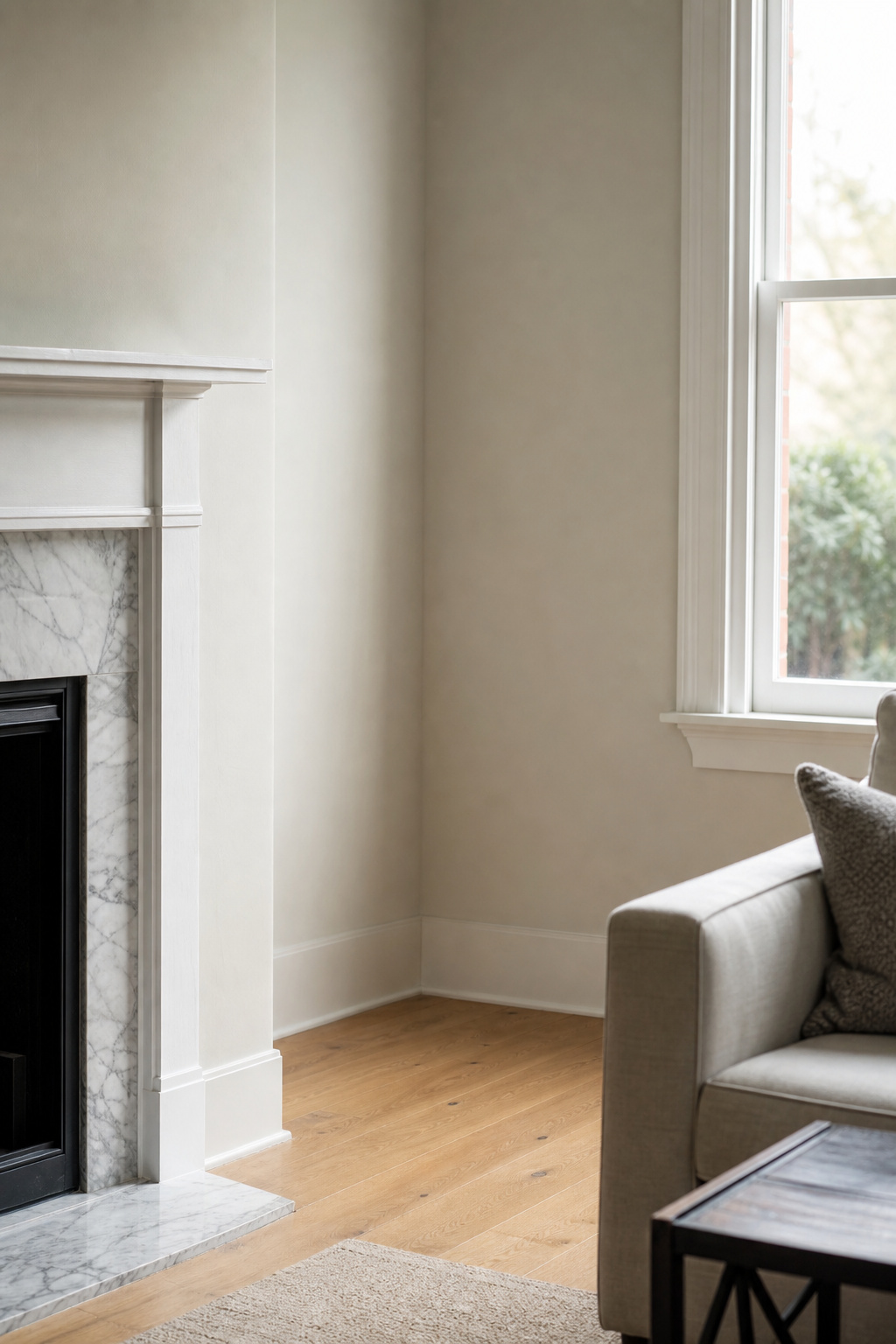 Empty room corner beside a fireplace where a floor vase would fit