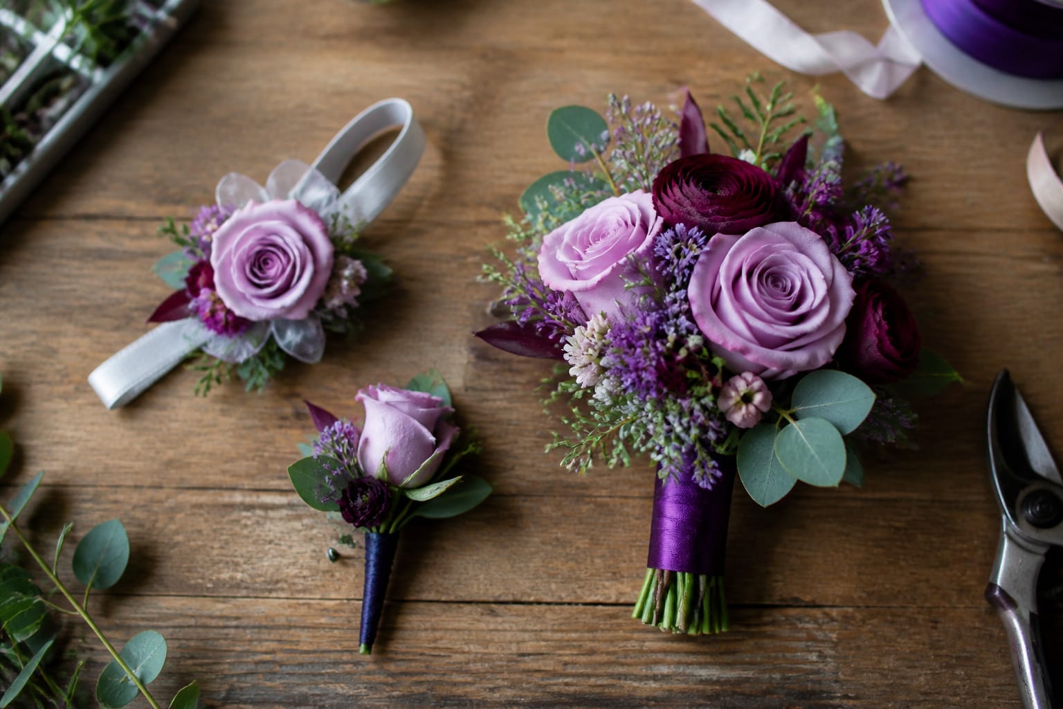 Finished prom corsage, boutonniere, and hand-held bouquet displayed together