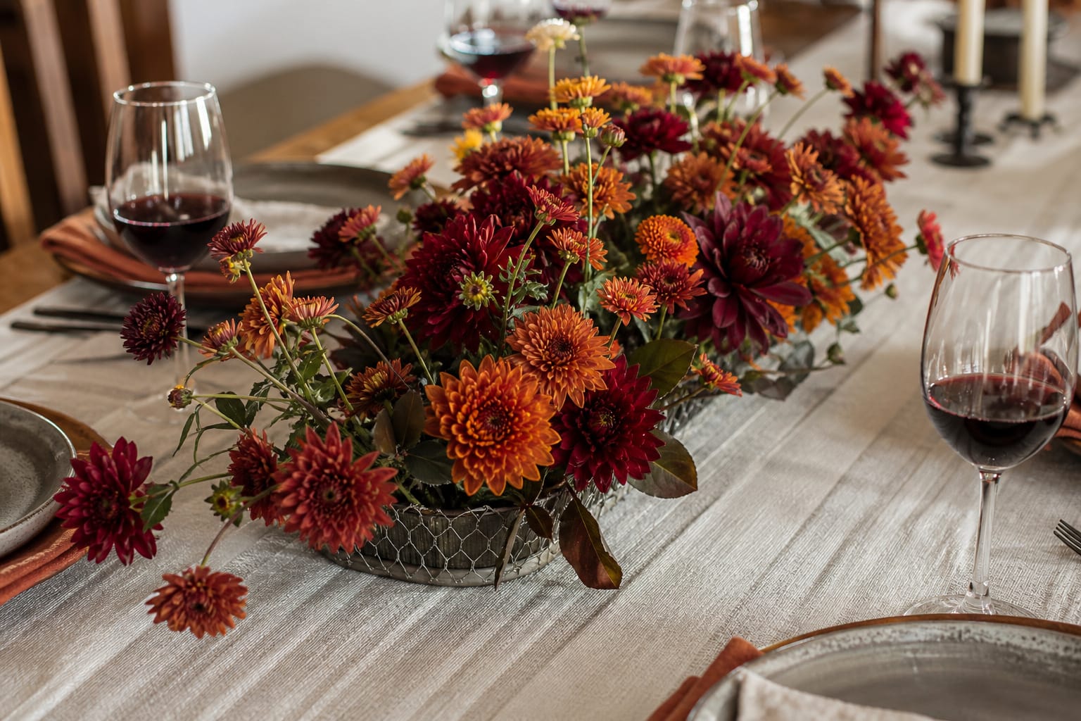 Low, foam-free fall centerpiece built with chicken wire mesh on a dinner party table