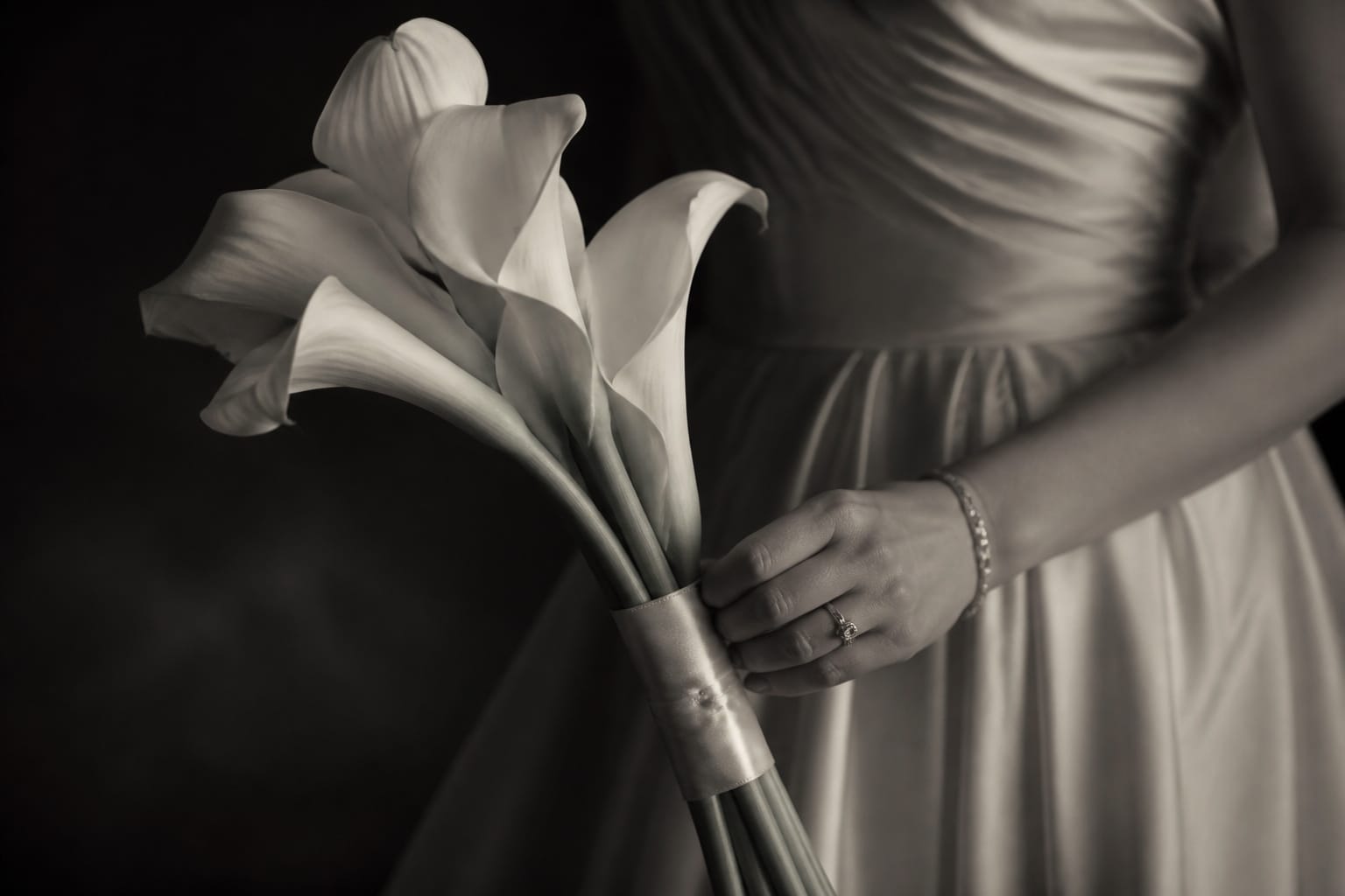 Old Hollywood bridal bouquet of long-stemmed white calla lilies wrapped in silk ribbon