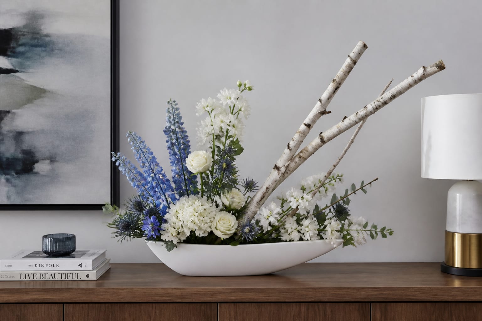 Modern asymmetrical blue-and-white Hanukkah floral arrangement in a white boat-shaped container