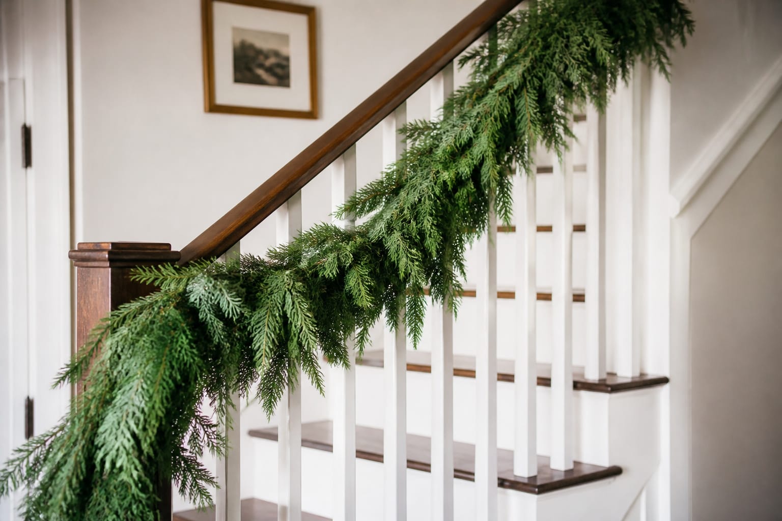 Fresh evergreen Christmas garland still holding up on a staircase after the holiday